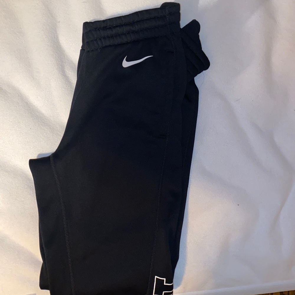 Nike with Just Do It logo on one leg sweatpants.